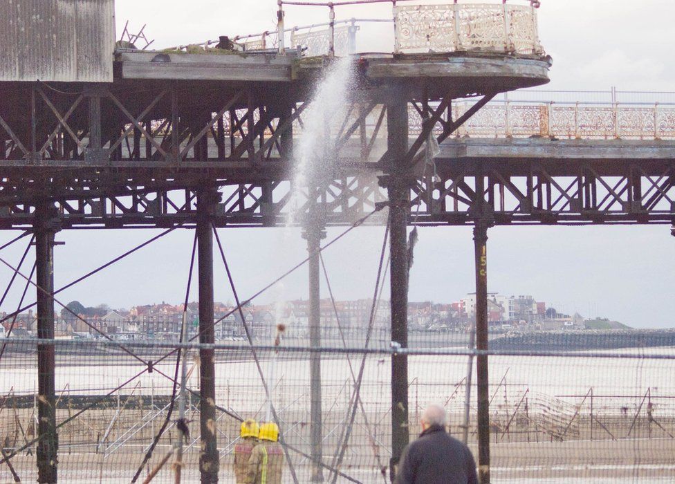 Firefighters tackle a fire at Colwyn Bay pier