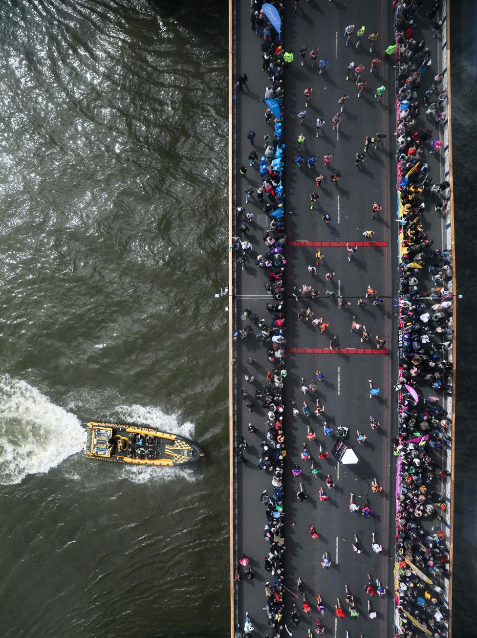 Runners cross Tower Bridge during the 2024 TCS London Marathon at on April 21, 2024 in London, England.