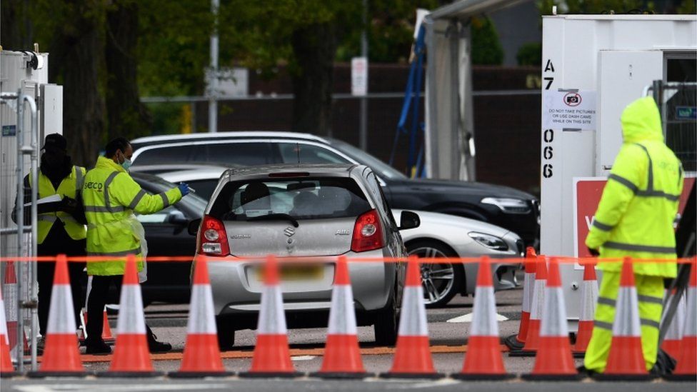A car arrives at an NHS coronavirus drive through testing facility at Lee Valley Leisure Centre in London,