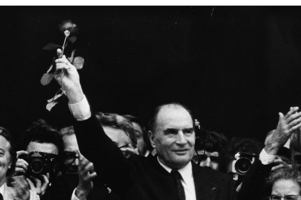 François Mitterand raising a rose in the air in victory, as the new President of France, at the Pantheon, Paris, 1981