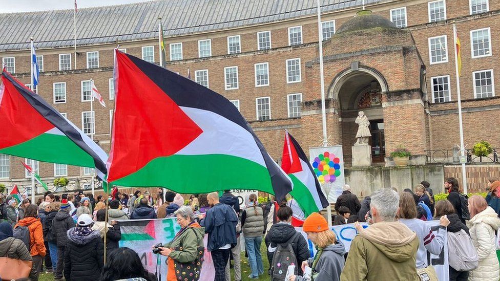 Protesters with Palestinian flags on College Green