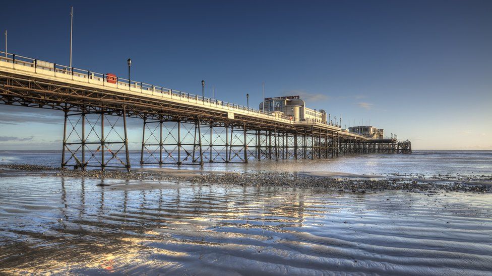 Worthing Pier at low tide during sunset