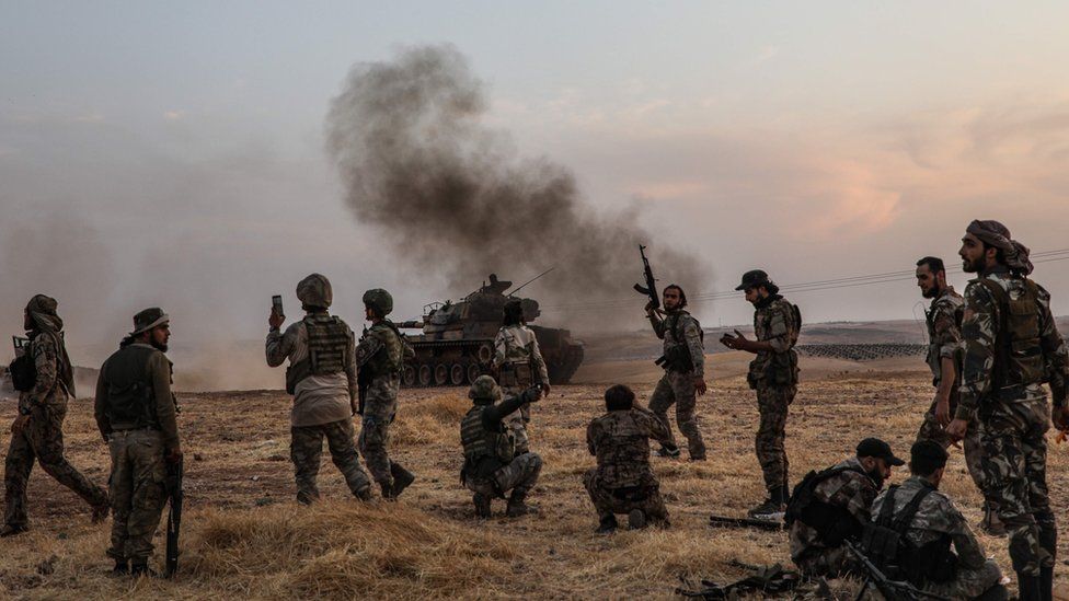 Turkish soldiers and allied Syrian fighters on the outskirts of the Syrian town of Manbij (14 October 2019)