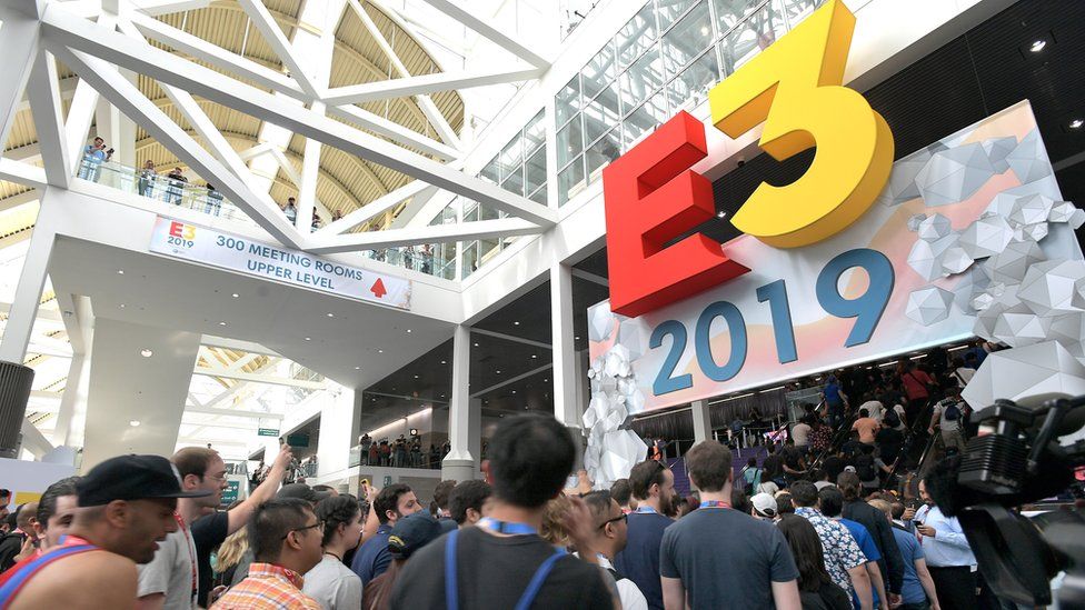 The E3 logo sits above a door as hundreds of attendees flow through the entrance into the conference centre