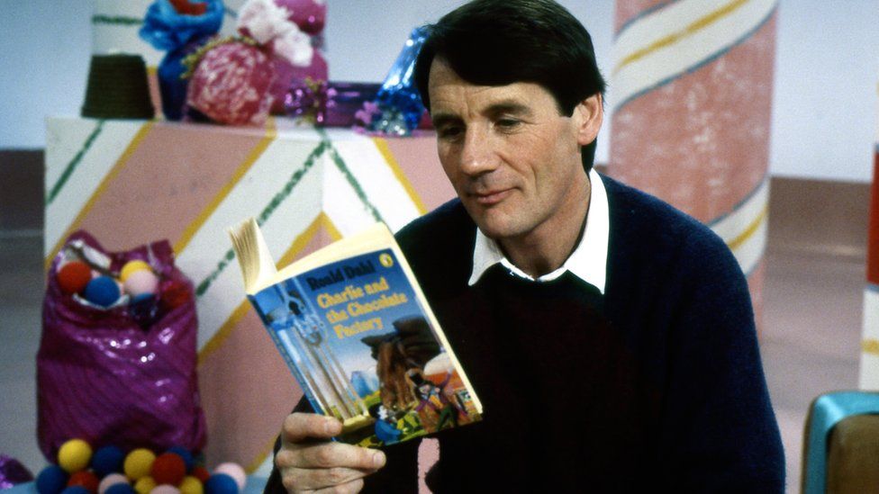 Michael Palin reading a copy of Charlie and the Chocolate Factory