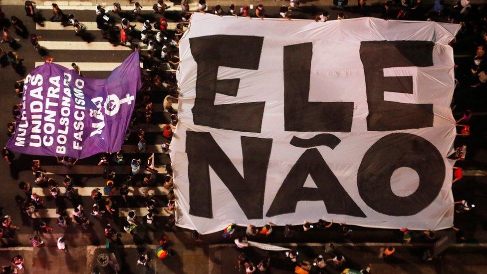 Aerial view of protesters holding a large "not him" banner in Sao Paulo