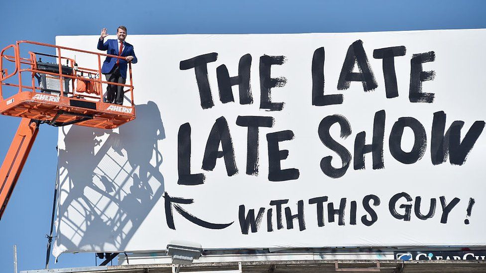 James Corden next to a billboard advertising The Late Late Show in Los Angeles, California in 2015