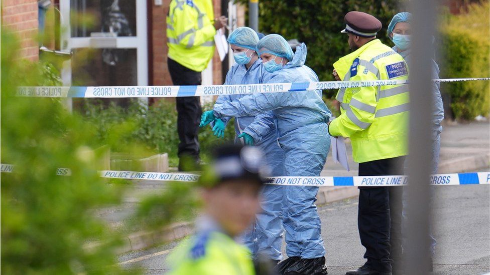 Forensic investigators work at the scene in Laing Close in Hainault, north east London