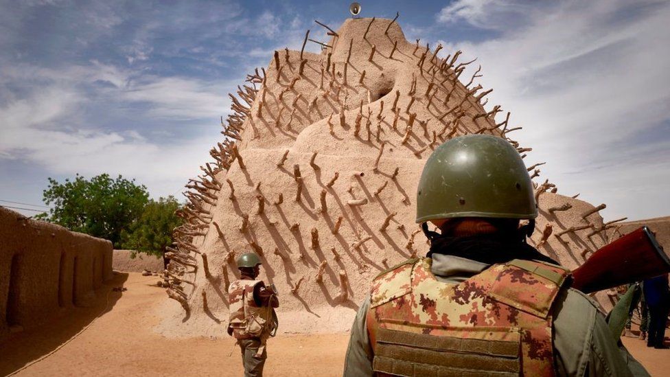 Soldiers of the Malian army patrol the archaeological site of the Tomb of Askia in Gao on March 10, 2020.