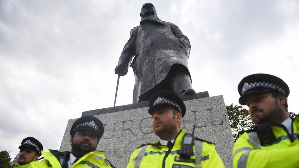 Churchill statue surrounded by police officers