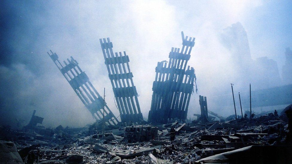 The rubble of the World Trade Center smoulders following a terrorist attack 11 September 2001 in New York