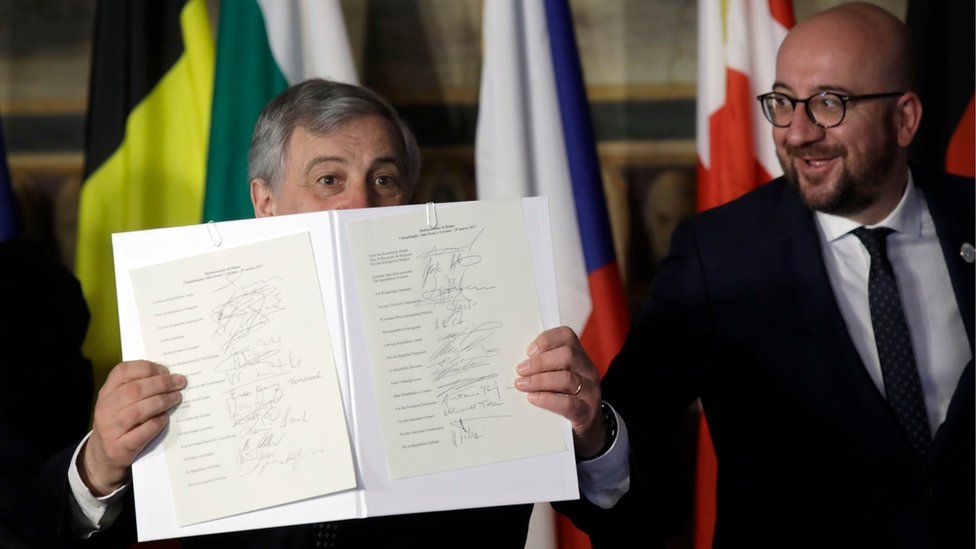 European Parliament President Antonio Tajani, left, holds up the Rome declaration, signed by EU leaders, during an EU summit meeting at the Orazi and Curiazi Hall in the Palazzo dei Conservatori in Rome on Saturday, March 25, 2017