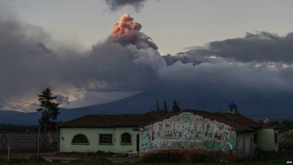 An ash cloud can be seen rising from the Cotopaxi volcano in the photo taken from Saquisili village on 15 August 2015