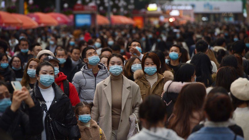 People wearing face masks visit Chunxi Road, the busiest commercial pedestrian Street in Chengdu, on November 28, 2020 in Chengdu, Sichuan Province of China.