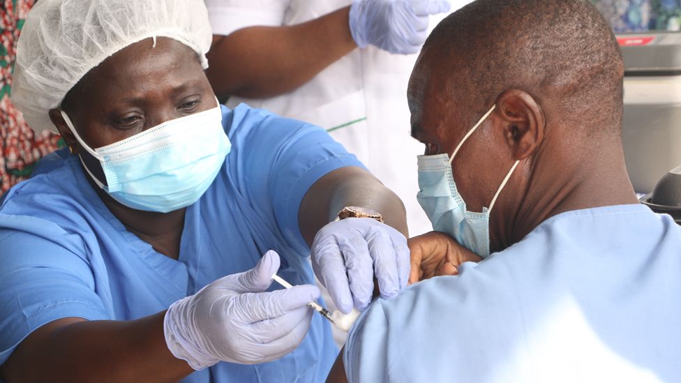 A person receives a dose of the Oxford/AstraZeneca coronavirus vaccine at the Cacovid isolation centre, in Nigeria.