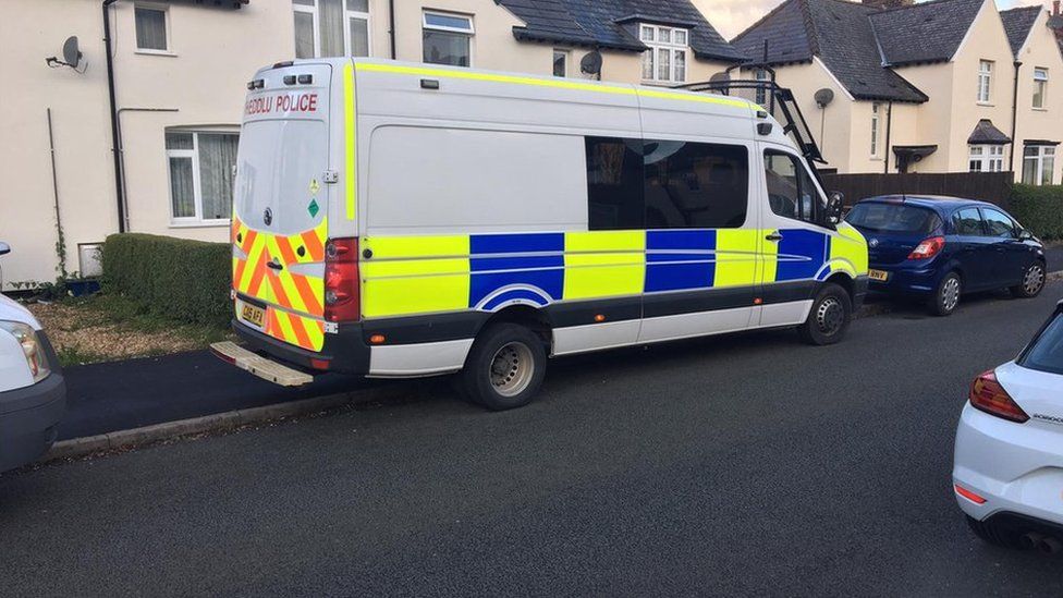 Police van outside a property in north Wales