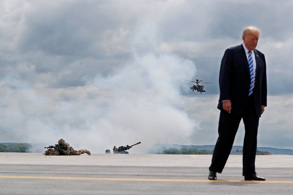 US President Donald Trump observes a demonstration with U.S. Army 10th Mountain Division troops, an attack helicopter and artillery as he visits Fort Drum, New York, U.S., 13 August 2018.