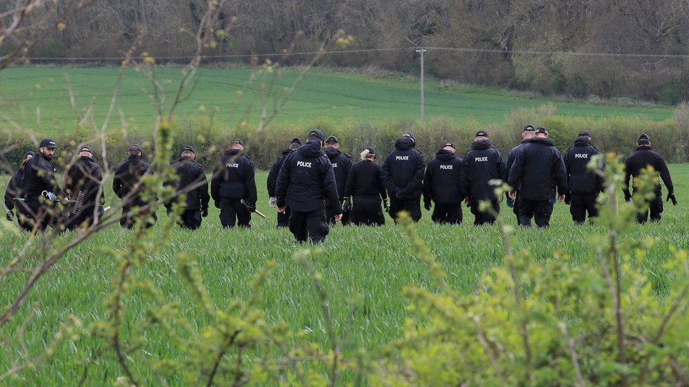 Police officers continue their search of fields close to the hamlet of Snowdown, near Aylesham