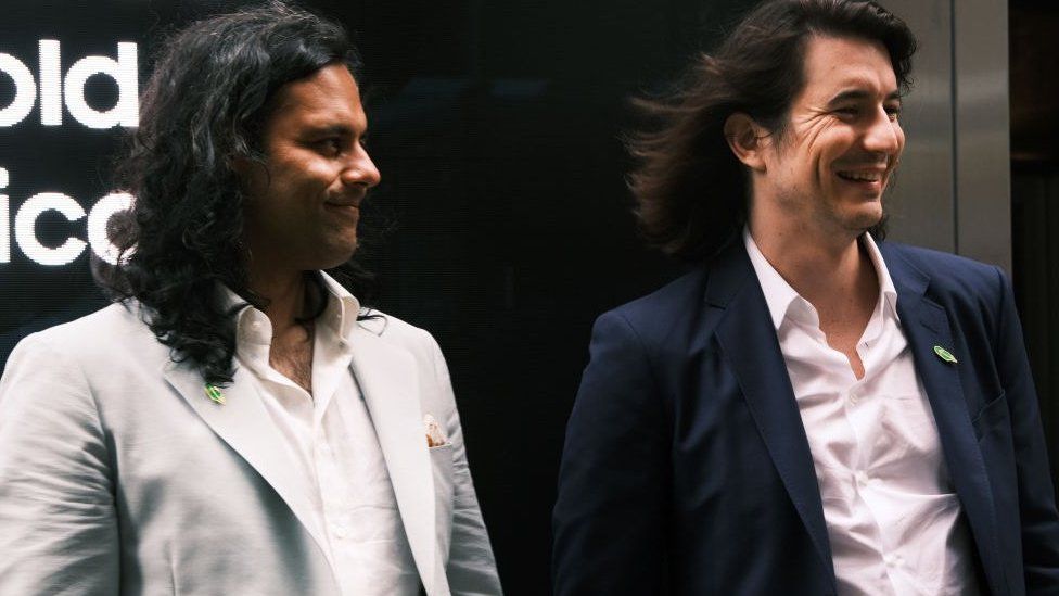 Baiju Bhatt (left) and Vlad Tenev, founders of the online brokerage Robinhood, walk along Wall Street after going public with an IPO earlier in the day on July 29