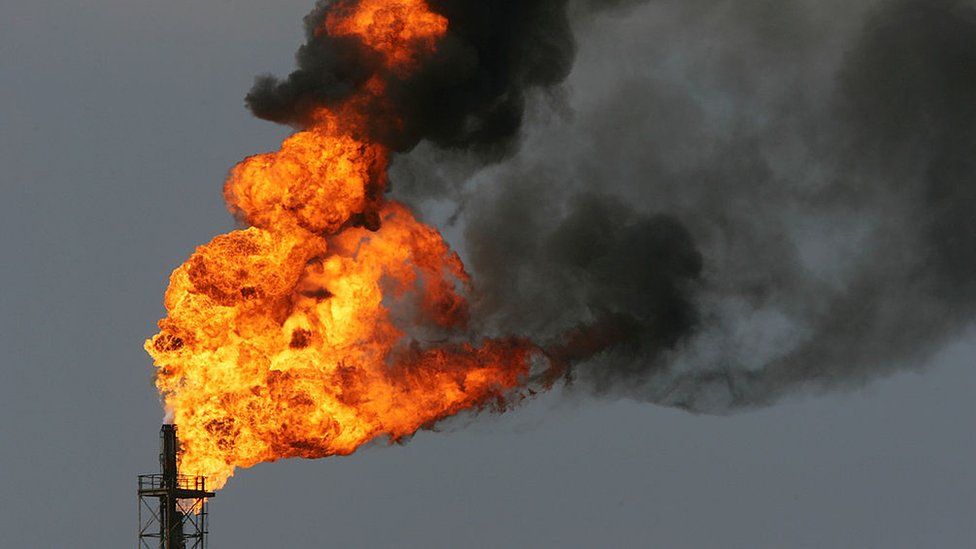 Flames rise in a burn-off of toxic gases at an oil refinery in the US