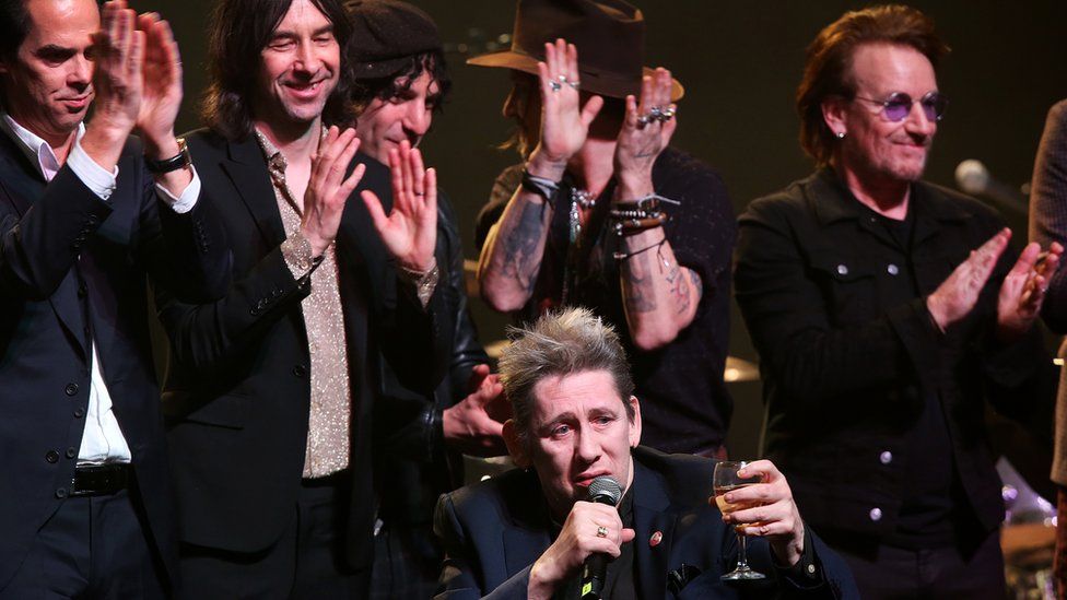 Shane is joined on stage by Bono and other musicians