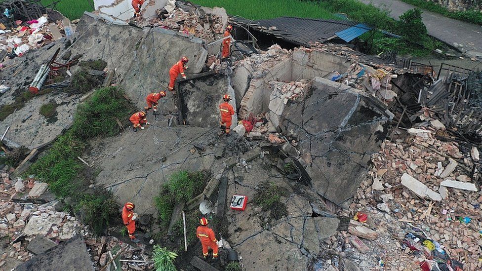 Rescue workers on a collapsed house after earthquakes hit Changning county in Yibin, Sichuan province, China June 18, 2019