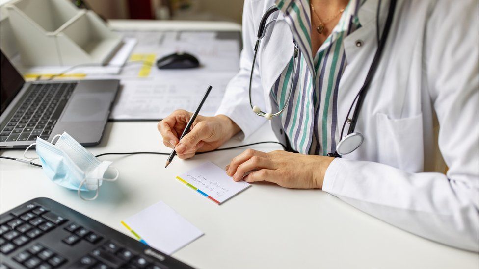 A doctor making notes, stock image