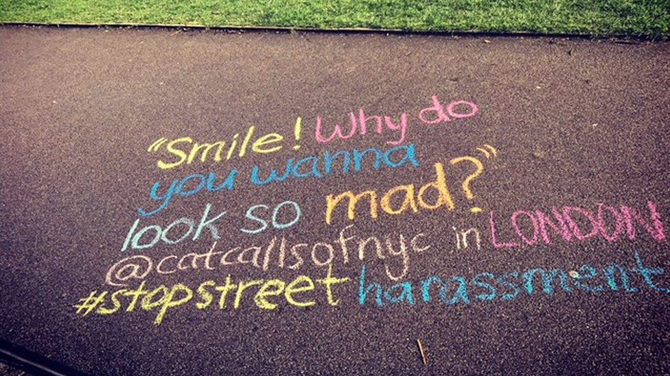 A catcall reading "Smile why do you want to look so mad?" written in chalk on the ground