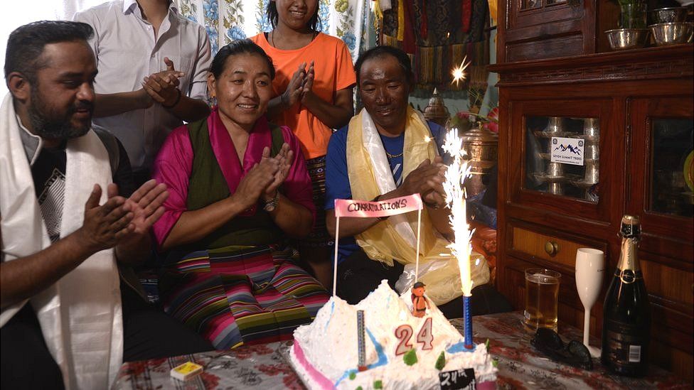 Lakpa Jangmu Sherpa (C) and Kami Rita Sherpa (R) at home with their family