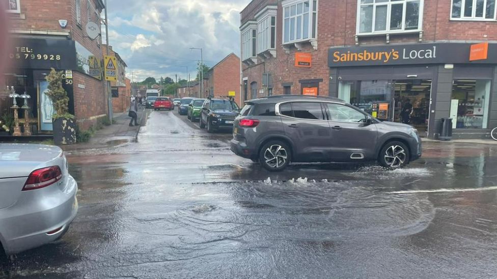 Cars driving through a puddle