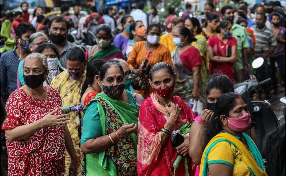 Indian people stand in a queue to receive a shot of the vaccine against COVID-19 during a mass vaccination drive organized by the Help Me Foundation NGO, in Mumbai, India, 19 August 2021