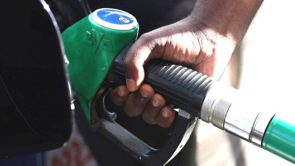 a person pumps petrol