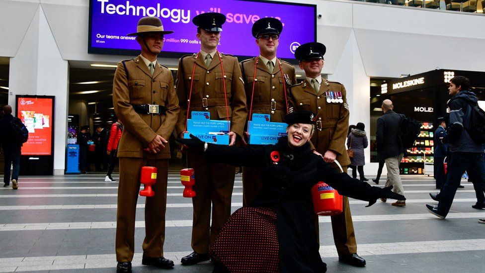 Singer Fiona Harrison with soldiers at New Street Station