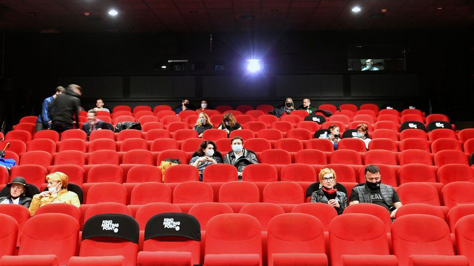 People in protective masks at a cinema in Sarajevo