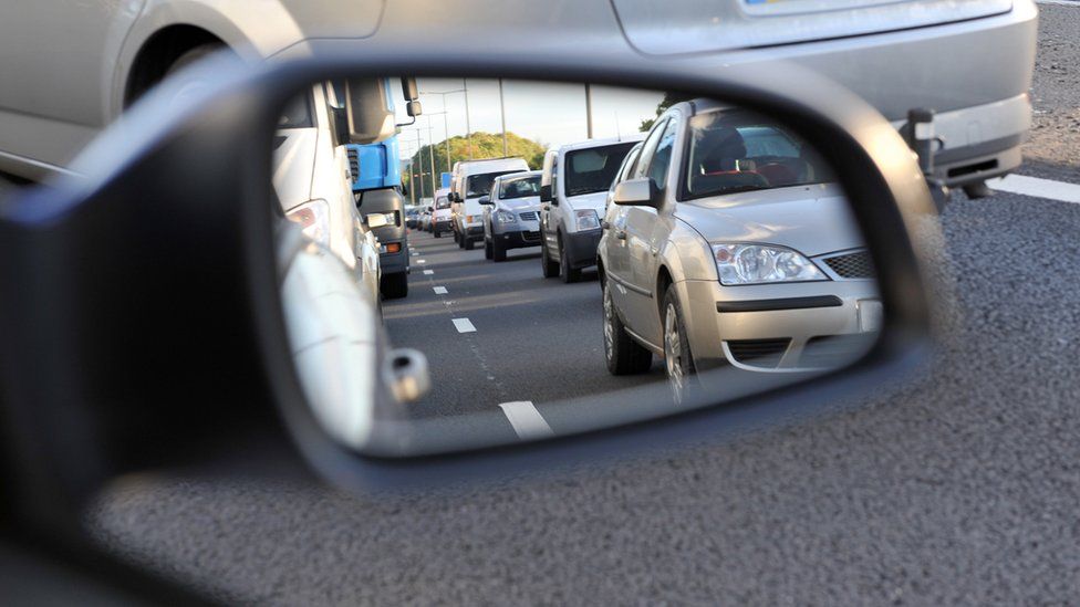 Traffic seen in rear-view mirror