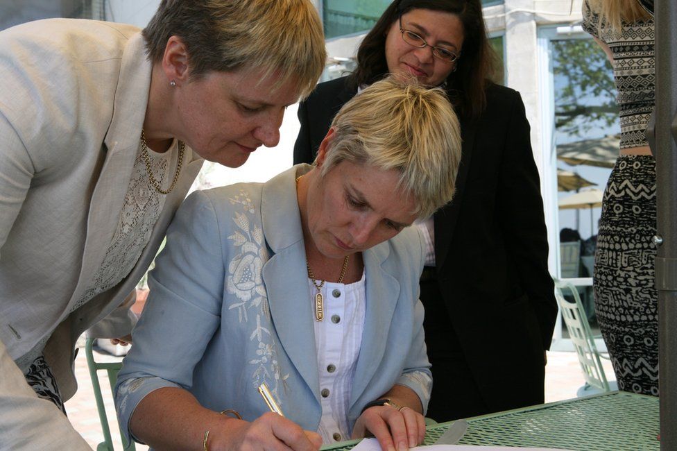 Orla Howard signing the marriage register in 2013, watched by Dr Grainne Courtney and wedding officiate New York City Councillor Rosie Mendez