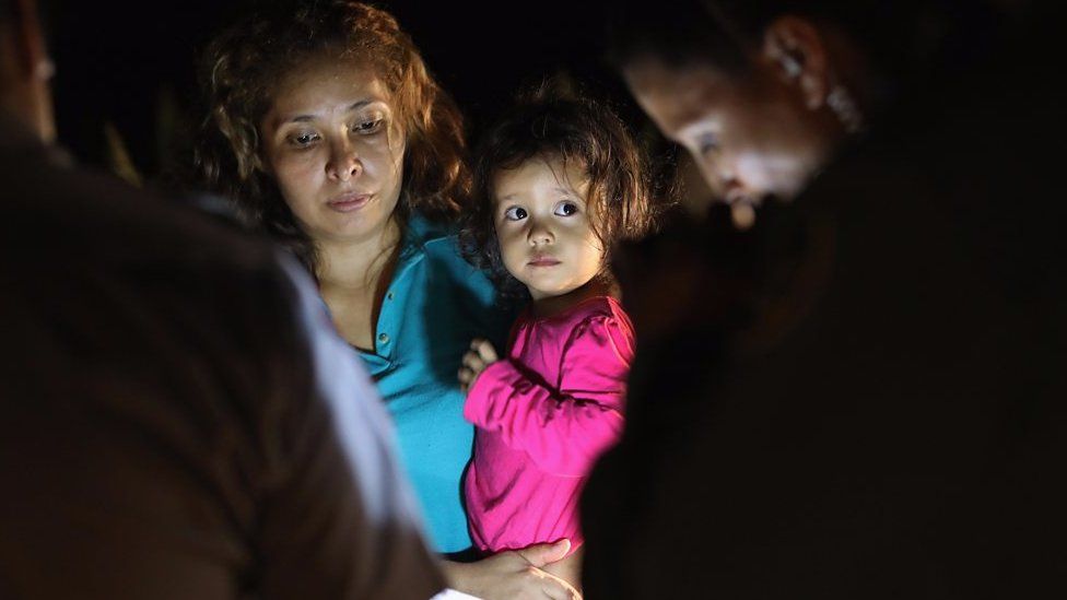 Child being held by her mother