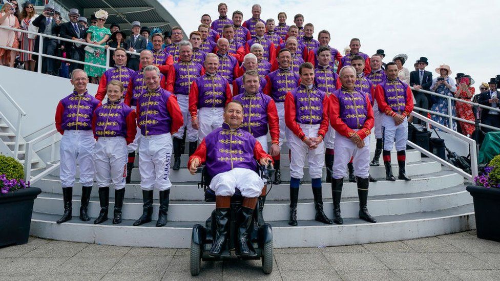 Jockeys who have raced for the Queen paying tribute to her dressed in silks of her racing colours at Epsom on Derby Day