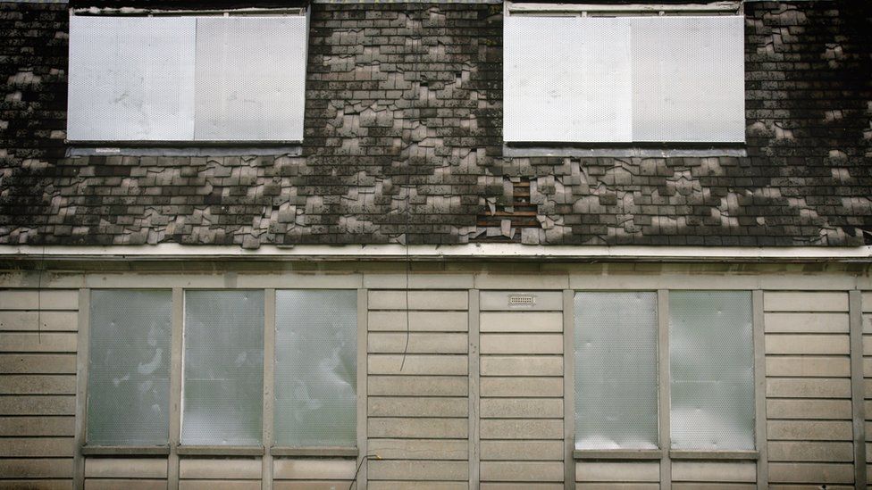 An empty and boarded up house