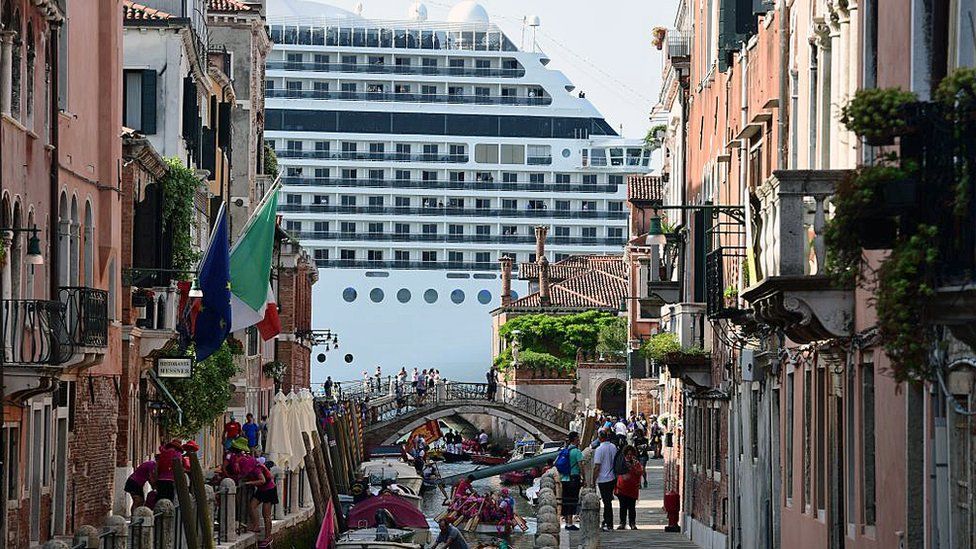 Cruise ship MSC Magnifica is seen from one of the canals leading into the Venice Lagoon on June 9, 2019 in Venice.