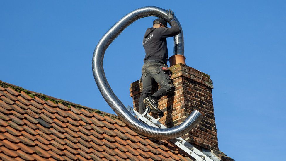 Man fits chimney lining