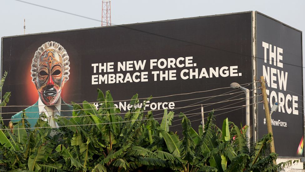 A general view of a billboard of an anonymous masked face accompanied by the words "The New Force. Embrace The Change." - Accra, Ghana - Wednesday 13 December 2023