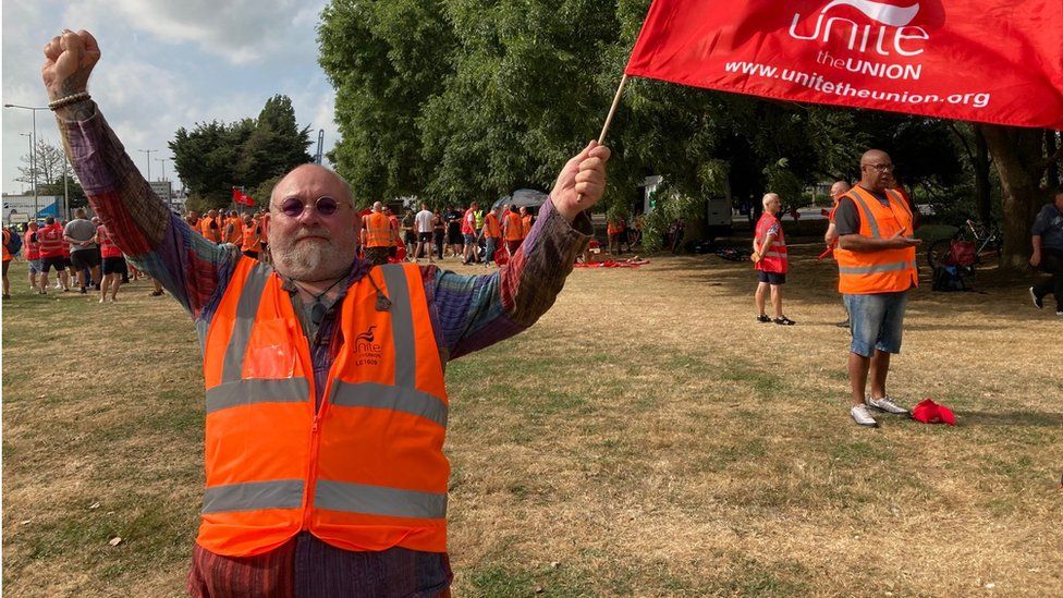 Steven Brown, a Port of Felixstowe working holding a union flag as he strikes for better pay
