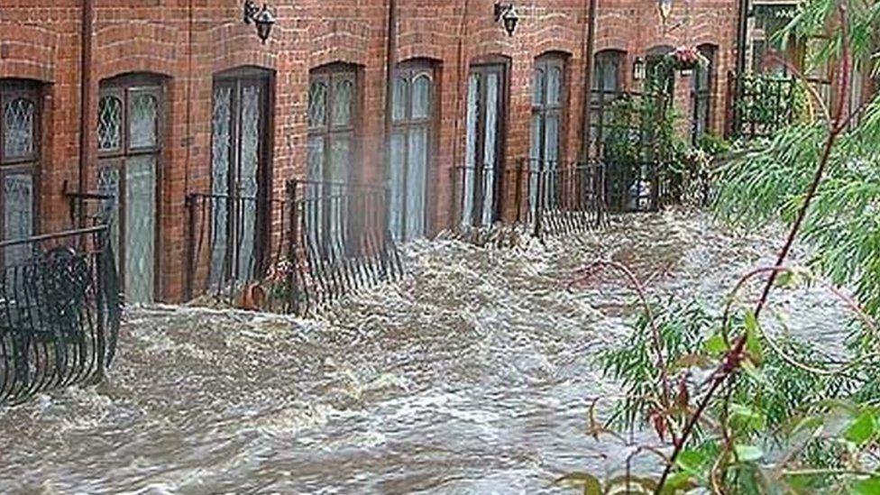 The River Loxley impacting residential properties at Rudyard Mews during a flood event in 2007