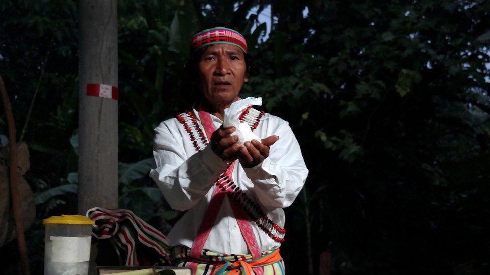 Shainkiam Yampik Wananch, a deacon ordained by the Catholic Church, holds up a host during a liturgy with indigenous Achuar people at a chapel in Wijint, a village in the Peruvian Amazon, Peru August 20, 2019.
