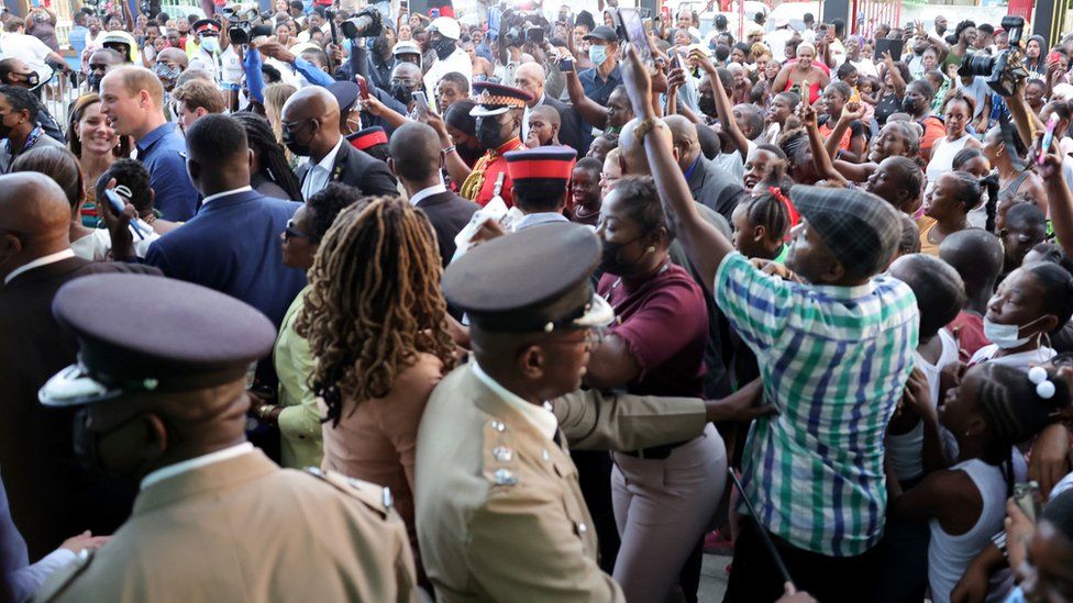 The Duke and Duchess of Cambridge walk through a crowd in Trench Town, Jamaica