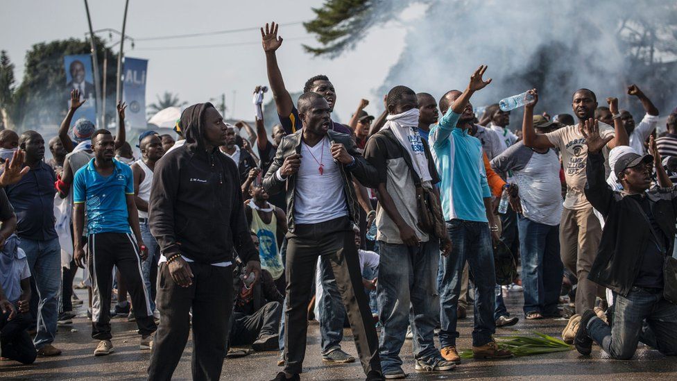 Supporters of Gabonese opposition leader Jean Ping face at a demonstration in the capital in Libreville in 2016