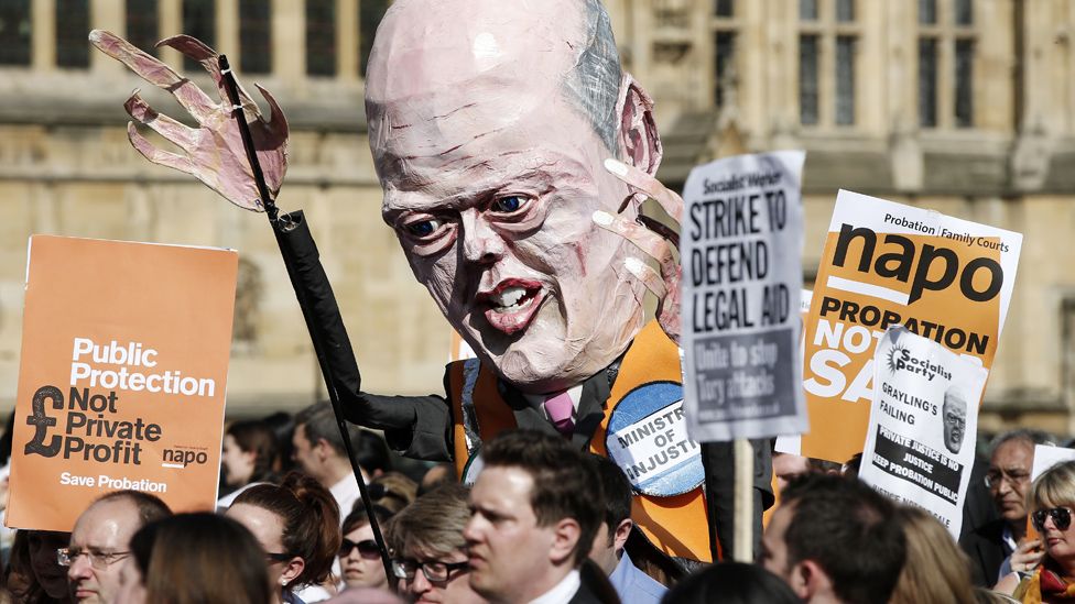 File image of a protester holding a giant papier-mache model of then-Justice Secretary Chris Grayling during a rally against changes to legal services in London in April 2014.