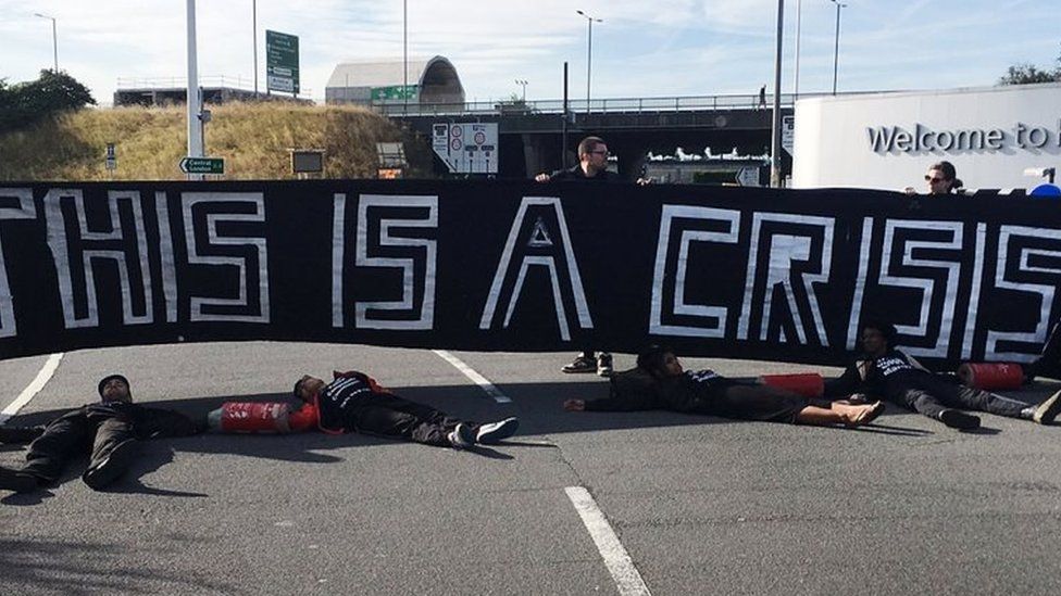 Protesters lying on a road en route to Heathrow