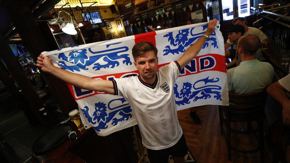 Soccer Football - Euro 2020 - Fans gather in Rome ahead of Ukraine v England - Rome, Italy - July 3, 2021 England fan poses with a flag in Rome before the match